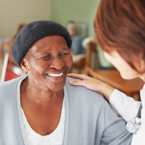 A patient smiling at her doctor